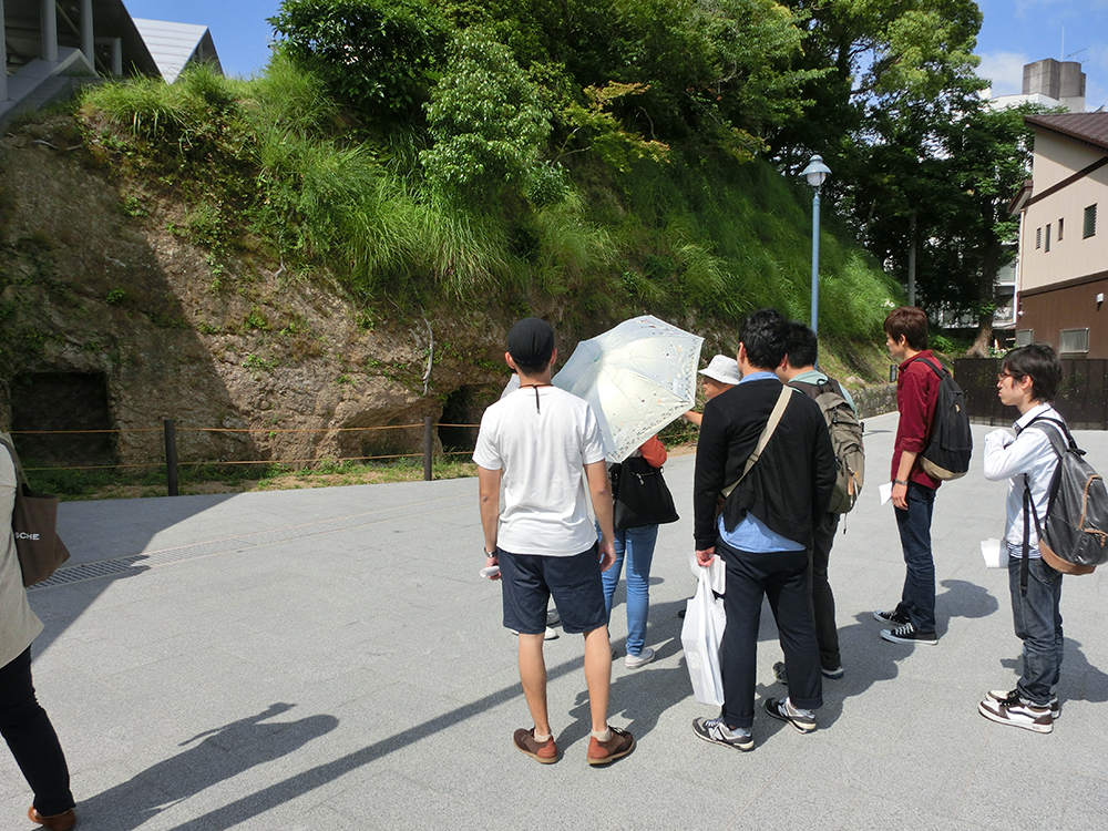 防空壕跡の説明を聴く学生